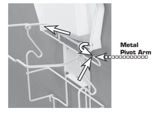 A black and white close-up instructional diagram showing the upper hinge assembly of an in-cupboard waste frame. The white wire rack connects to a white plastic lid mechanism mounted against a grey background. Graphic elements include a large horizontal arrow pointing left toward the hinge point, an upward-pointing arrow indicating the connection point, and a curved arrow showing the rotational movement of the hinge. The text "Metal Pivot Arm" is positioned on the right with a dotted graphic pointing toward the pivoting metal rod.